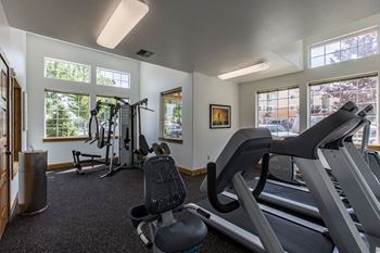 The gym with treadmills and exercise equipment at the enclave at quail springs apartments